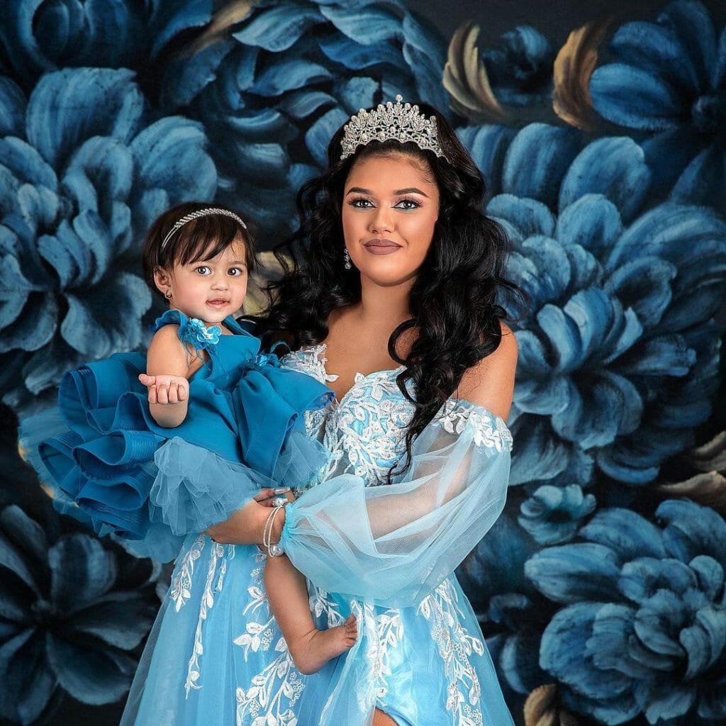 mother and daugther in front of blue floral photo backdrop